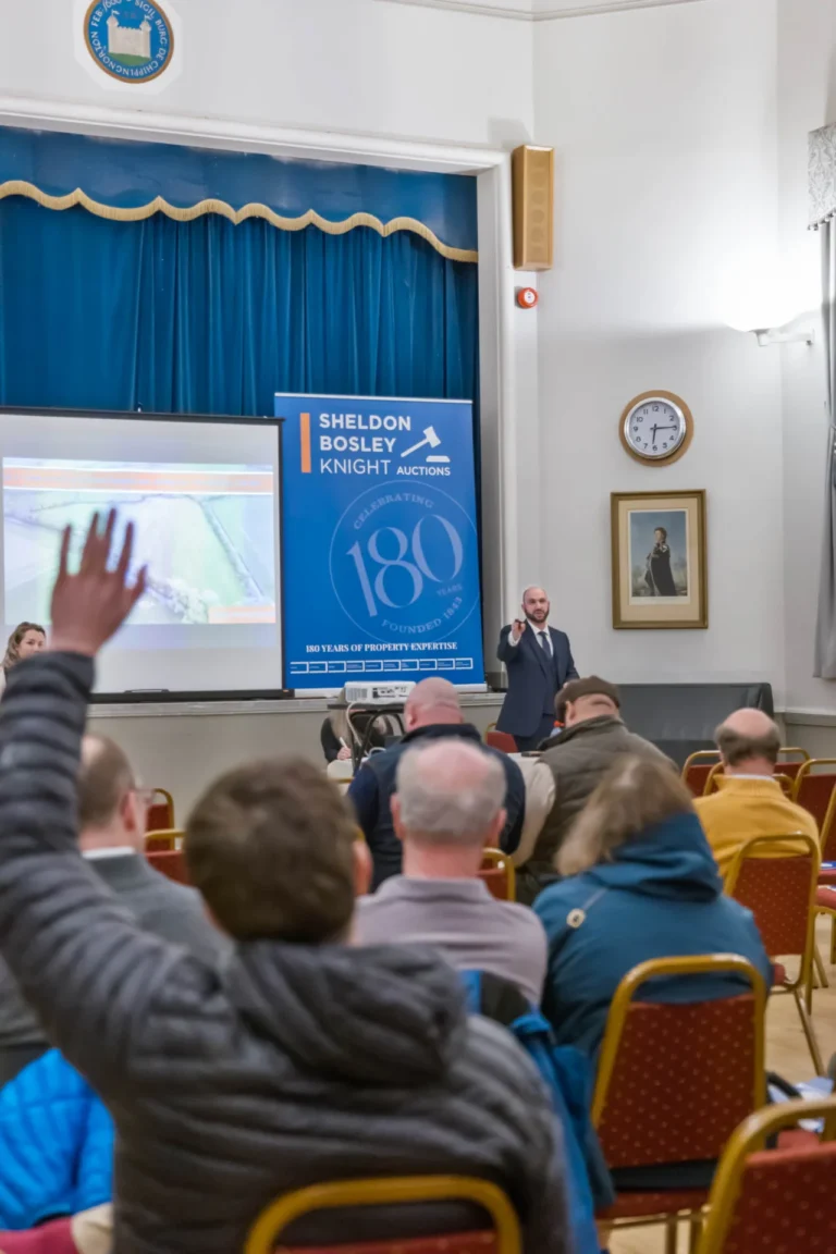 Man signalling a bid at an auction